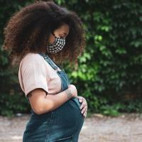 Pregnant woman wearing a fabric face mask